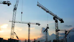 construction cranes at sunset construction cranes at sunset