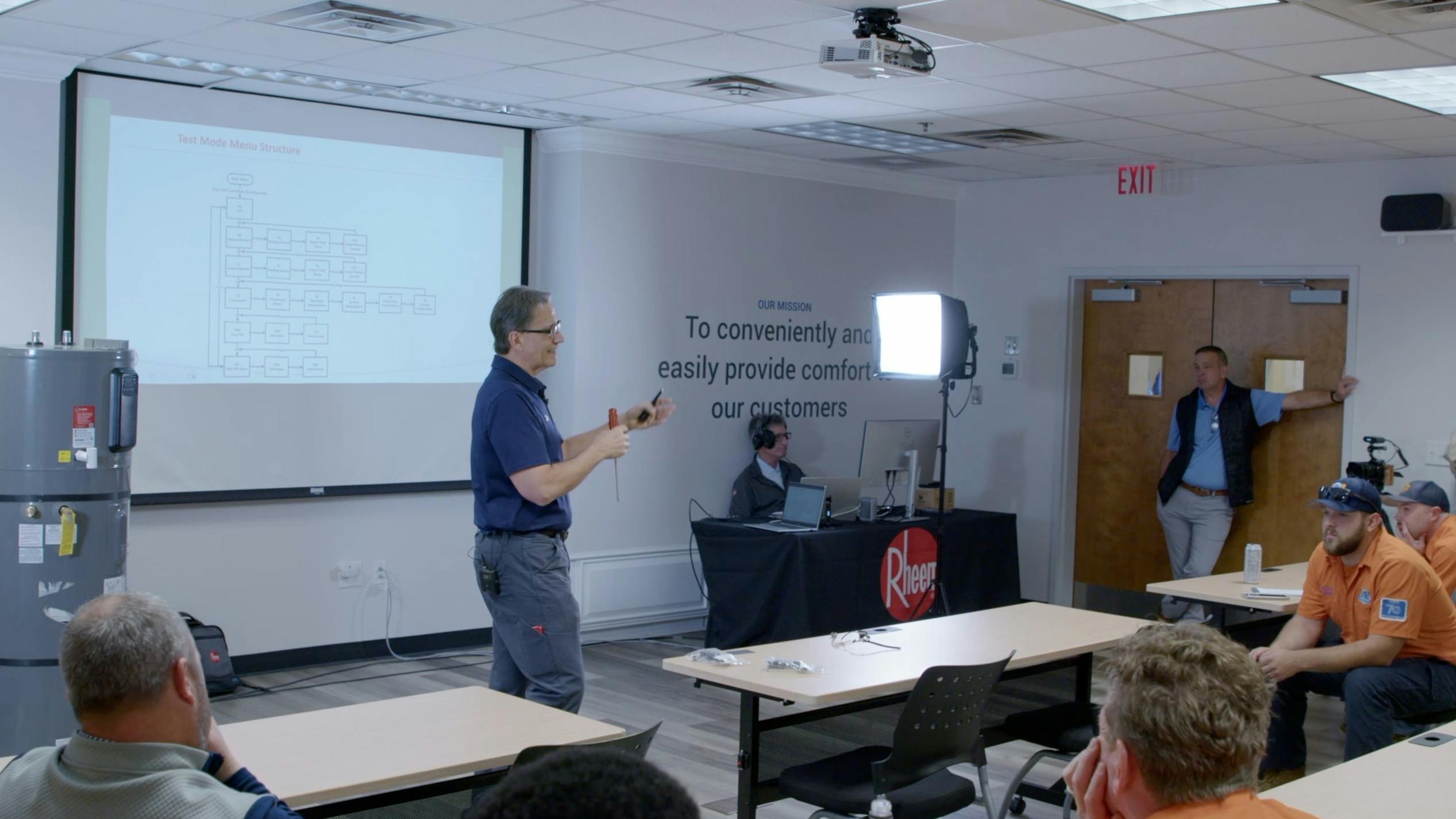 Tim House, Master Plumber, conducts heat pump water heater training for Rheem.
