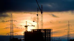 construction cranes at sunset. construction cranes at sunset.