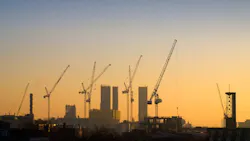 construction cranes at sunrise. construction cranes at sunrise.