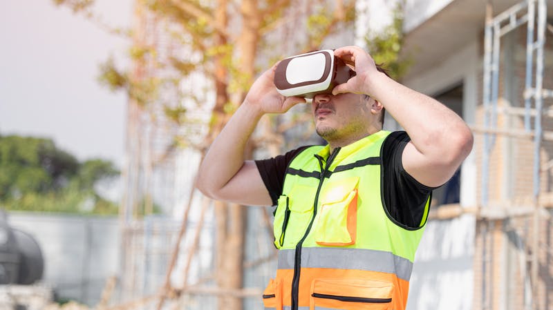 Construction worker using a VR headset on the job site.