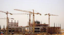 Construction cranes on the job site. Construction cranes on the job site.