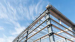 Steel frame workshop is under construction against a blue sky Steel frame workshop is under construction against a blue sky