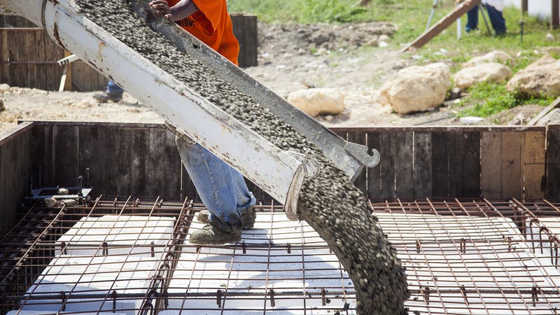 Pouring the concrete foundation of a house.