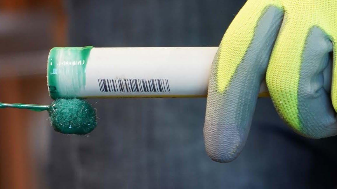 applying solvent cement to a CPVC pipe section