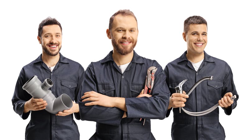 Team of plumbers holding plumbing equipment