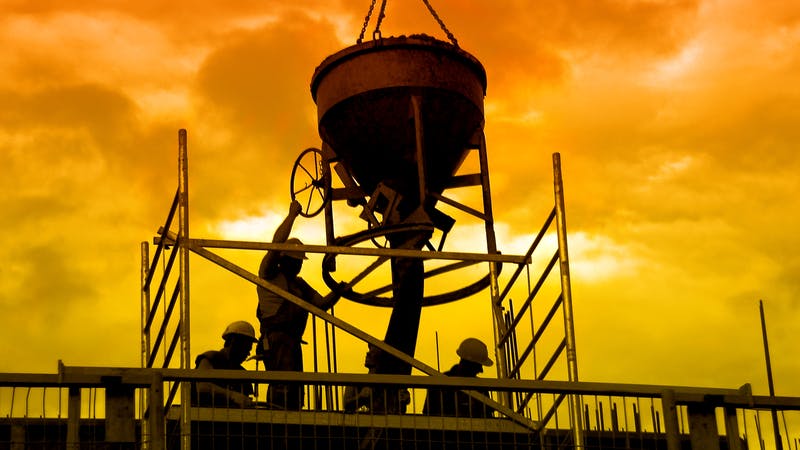 construction workers pouring concrete