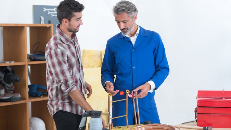 plumbing apprentice with instructor