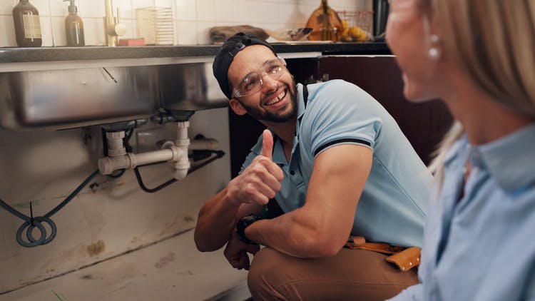 plumber with satisfied customer