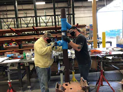 Finishing a pipe assembly at John W. Danforth Co. Finishing a pipe assembly at John W. Danforth Co.