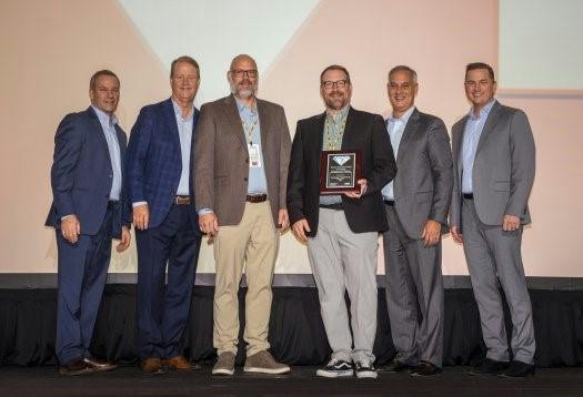 Kundinger representatives are accepting the award from Parker Hannifin representatives at the Parker National Sales Meeting: Michael Delaney (from left), vice president of industrial sales and distribution, Parker; Michael O&rsquo;Hara, vice president of global sales and marketing, Parker; Tom E. Kundinger, vice president and chief operating officer, Kundinger; Paul Kundinger, president, Kundinger; Andrew Ross, president and chief operating officer, Parker; and Douglas Gilbert, vice president of sales and marketing, Parker.