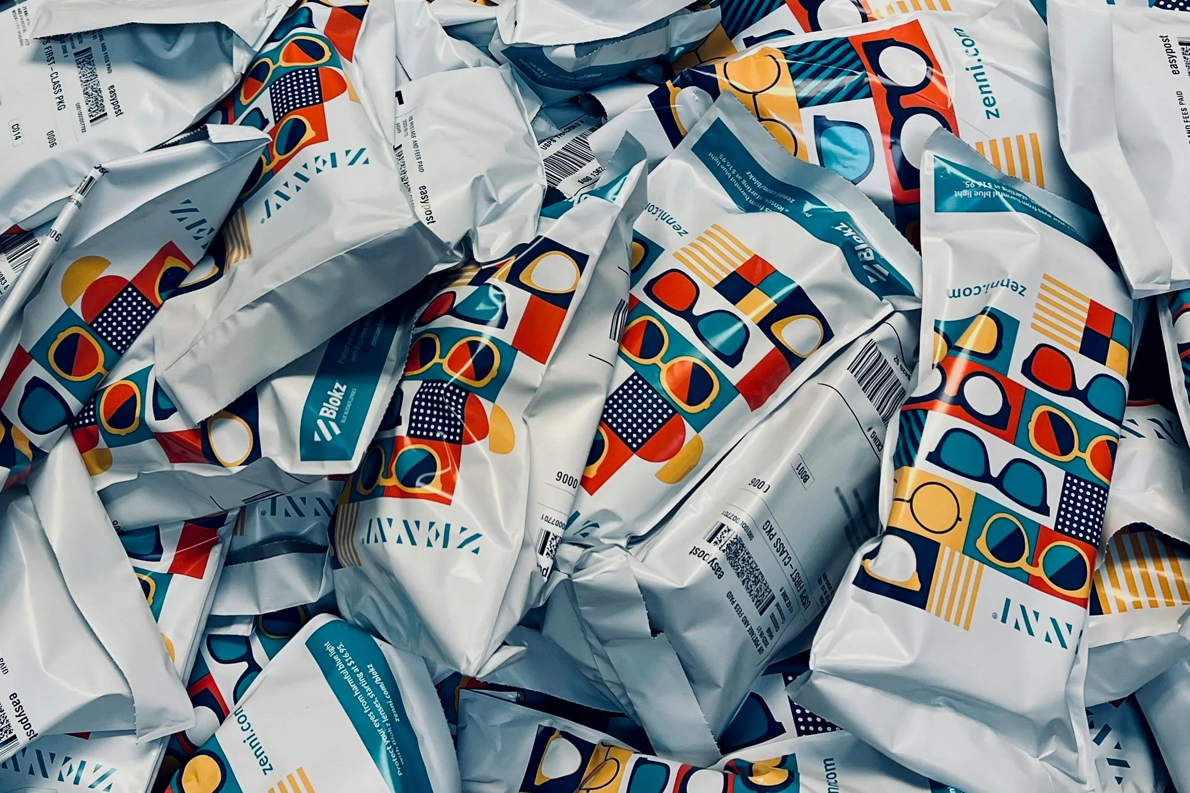 Figure 1: For years, workers have manually placed each pair of glasses into a clamshell case and then inserted the case into a tabletop mechanical bagging machine that generates a labeled polybag, ready for shipment. Figure 1: For years, workers have manually placed each pair of glasses into a clamshell case and then inserted the case into a tabletop mechanical bagging machine that generates a labeled polybag, ready for shipment.