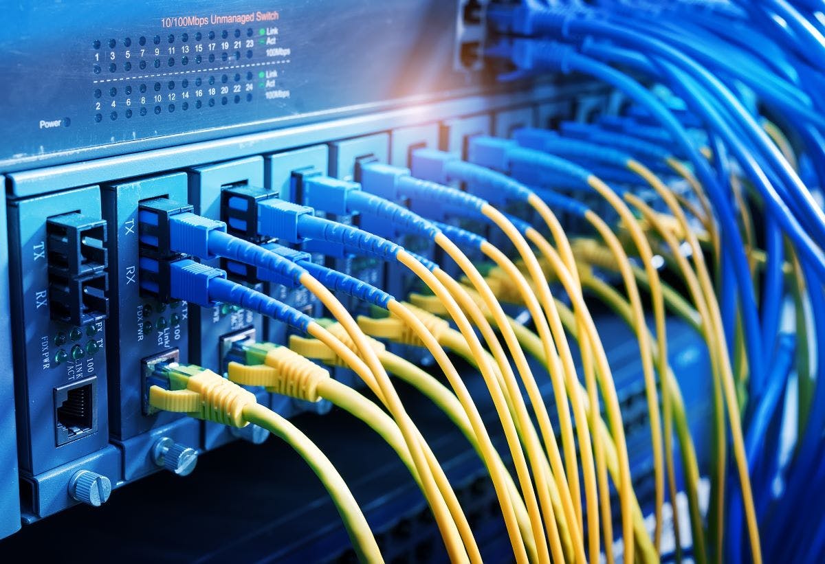 Fiber Optic cables connected to an optic ports and Network cables