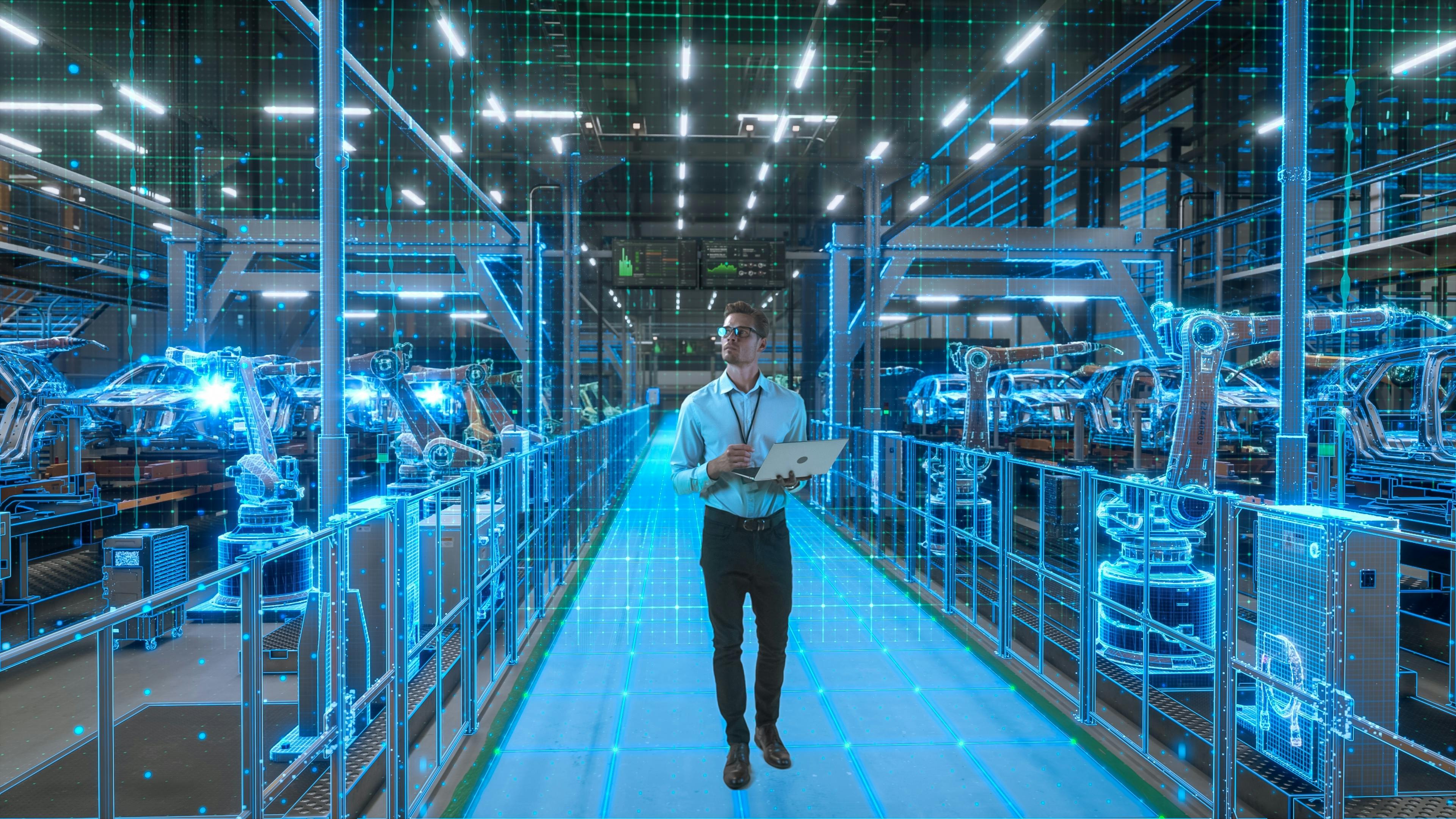 Engineer With Laptop Activates Autonomous EV Factory Digitization