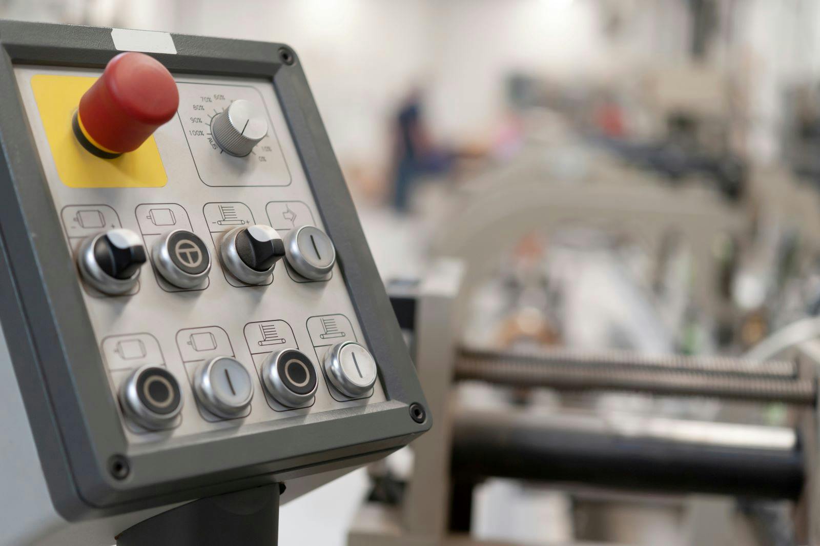 Isolated control panel in an empty production hall of a company with a blurred background
