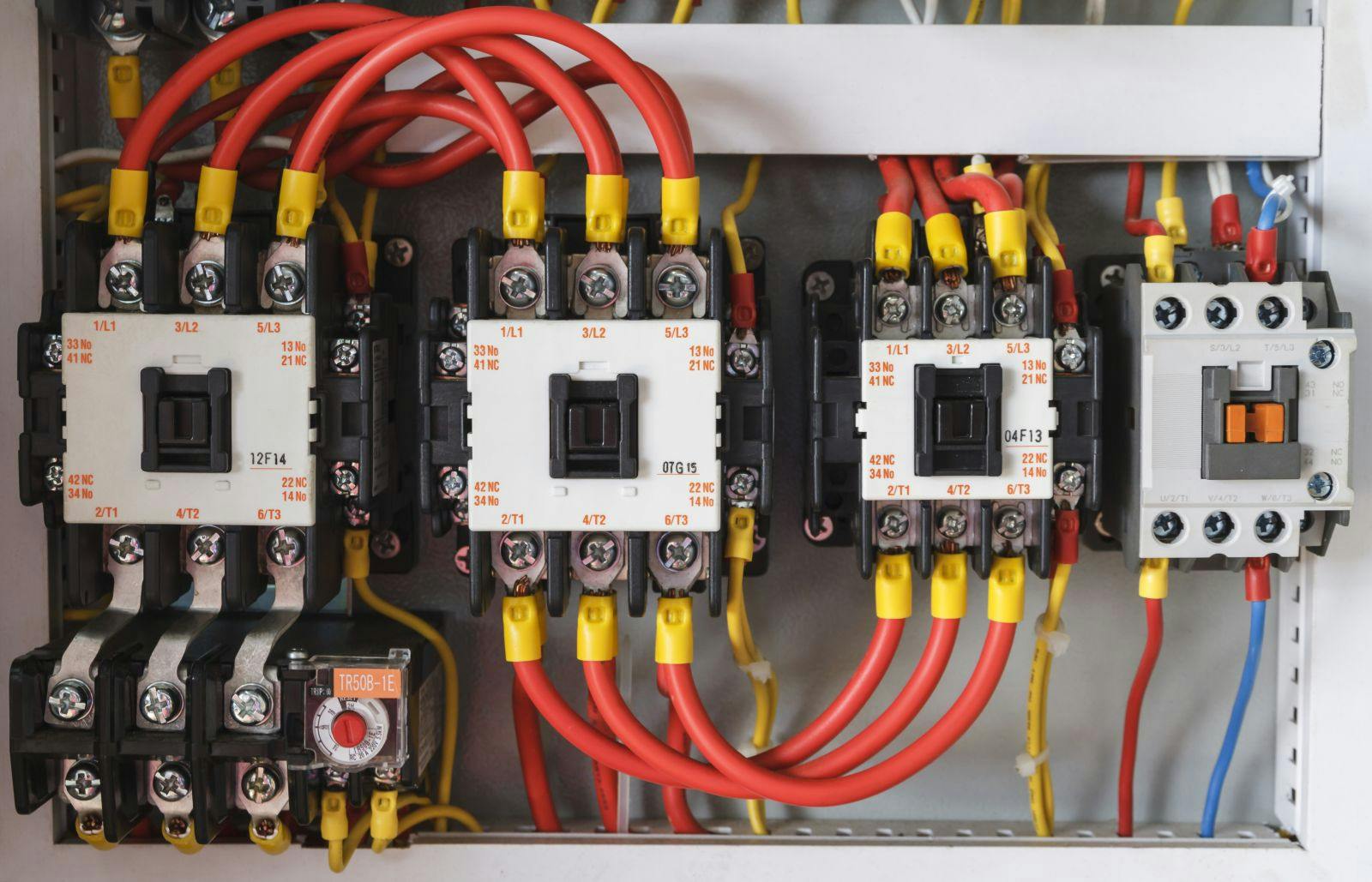 Close-up electrical wiring with fuses and contactors.