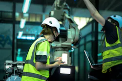 A robotics engineer uses a tablet to program a robot with a machine vision system, while her colleague calibrates the end-of-arm tooling on another unit in a system integration lab. A robotics engineer uses a tablet to program a robot with a machine vision system, while her colleague calibrates the end-of-arm tooling on another unit in a system integration lab.