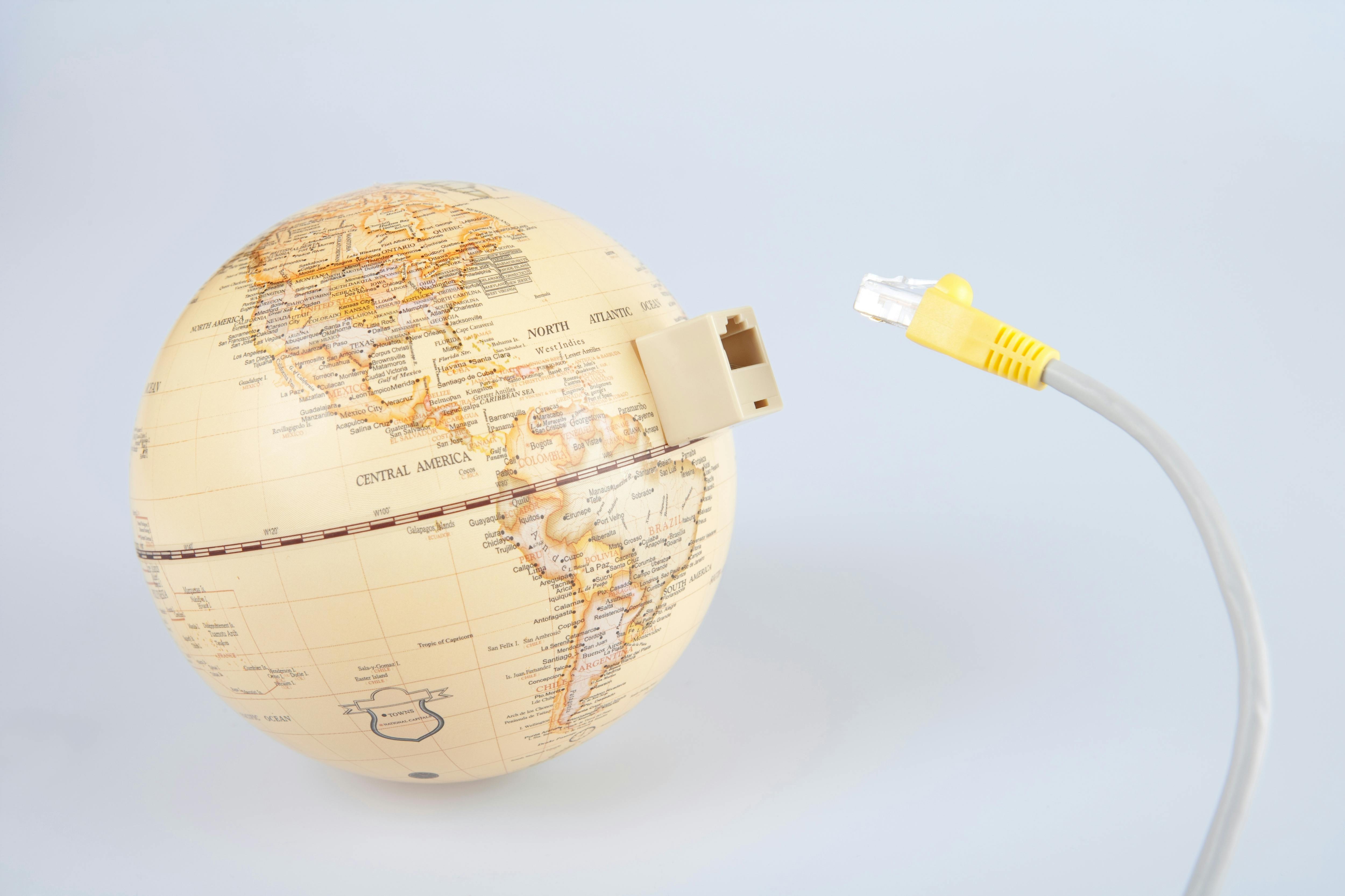 Globe with ethernet cable showing connection to the world