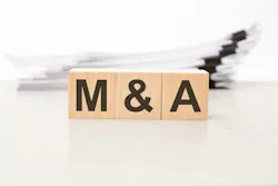 text m and a - Mergers and Acquisitions - on wooden blocks. the background is a business papers. finance concept. white background text m and a - Mergers and Acquisitions - on wooden blocks. the background is a business papers. finance concept. white background