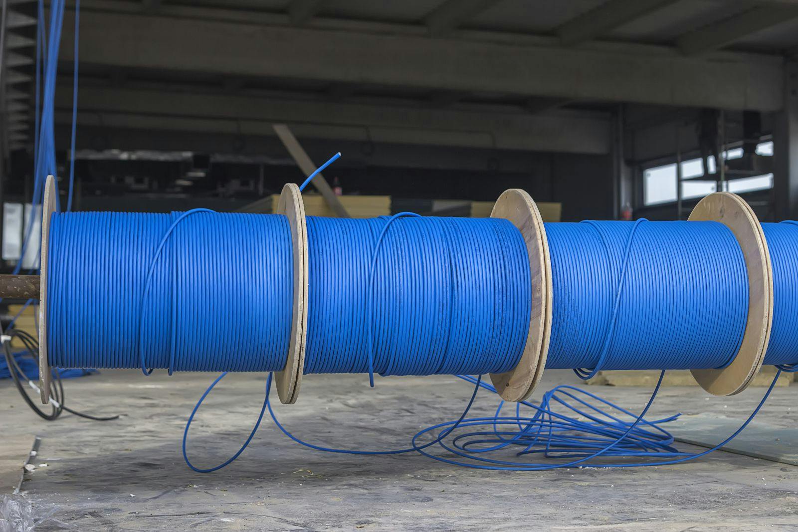 Blue ftp ethernet cable reels on a building site.
