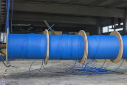 Blue ftp ethernet cable reels on a building site. Blue ftp ethernet cable reels on a building site.