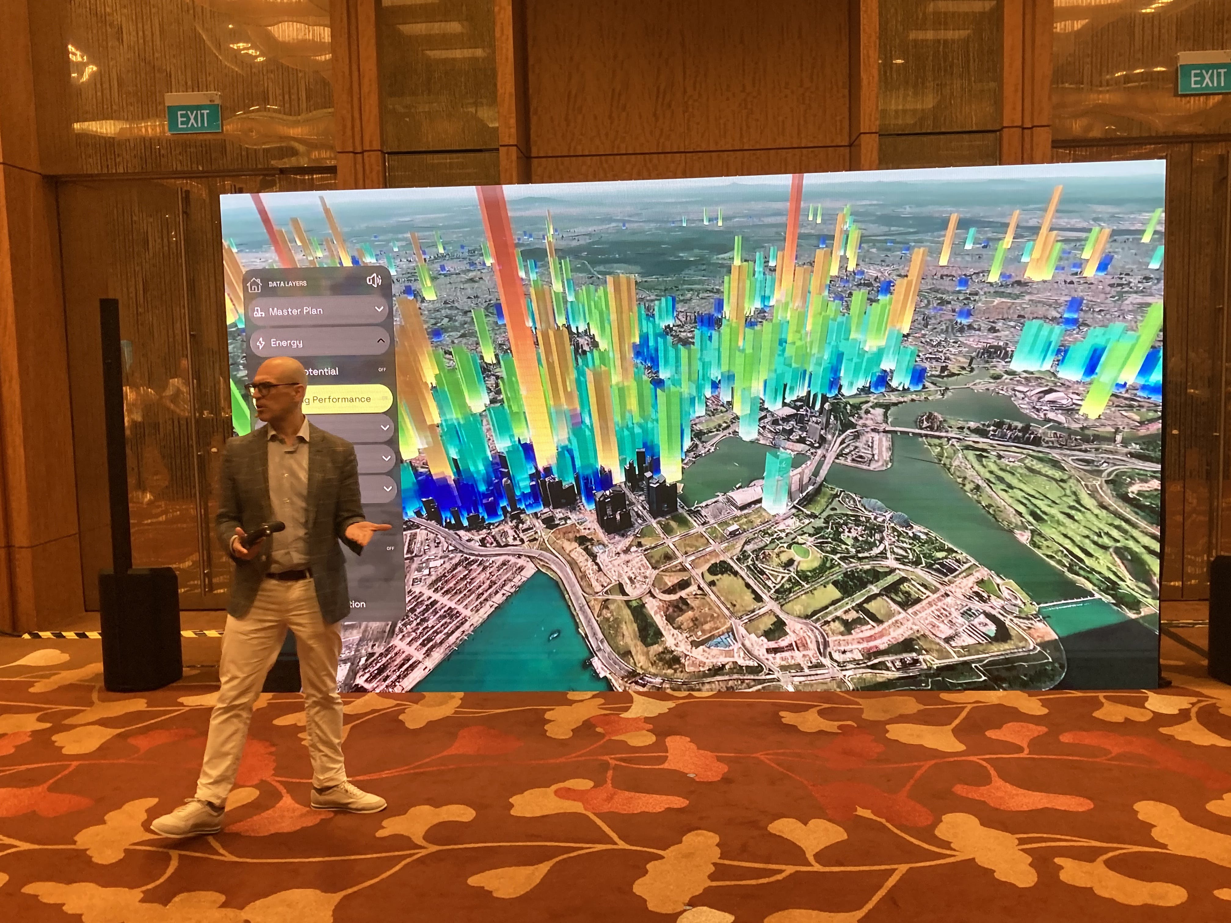 Greg Demchak, senior director of the Innovation Lab (iLab) at Bentley, shows how its software and visualization algorithms integrate multiple public data sources, turn 2D maps into 3D representations, add Google Maps tiles to show energy use, and include sensor data for water pressure to show resources used by many of the buildings in downtown Singapore.