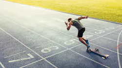 Rear view of an athlete starting his sprint on an all-weather running track Rear view of an athlete starting his sprint on an all-weather running track