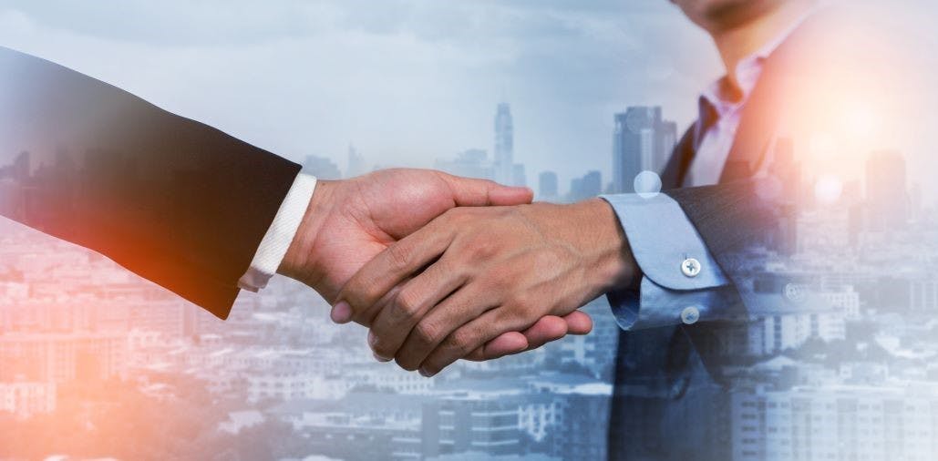 Businessmen making handshake with partner