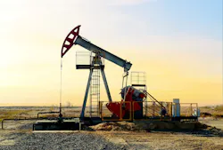 Crude oil pump jack at oilfield on sunset background Crude oil pump jack at oilfield on sunset background