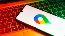 Smartphone on surface showing Google Maps logo Smartphone on surface showing Google Maps logo