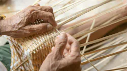Senior man hands manually weaving bamboo. Senior man hands manually weaving bamboo.