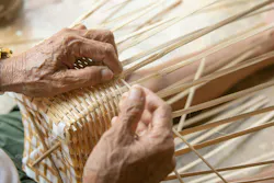 Senior man hands manually weaving bamboo. Senior man hands manually weaving bamboo.