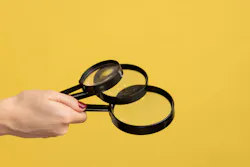 Profile side view closeup of woman hand holding several magnify glasses, loupe. Indoor studio shot isolated on yellow background. Profile side view closeup of woman hand holding several magnify glasses, loupe. Indoor studio shot isolated on yellow background.