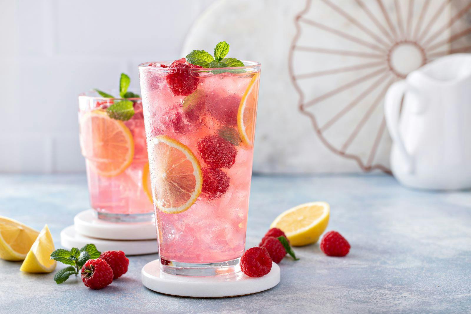 Spring or summer refreshing cold cocktail or mocktail with berries and lemon, raspberry lemonade