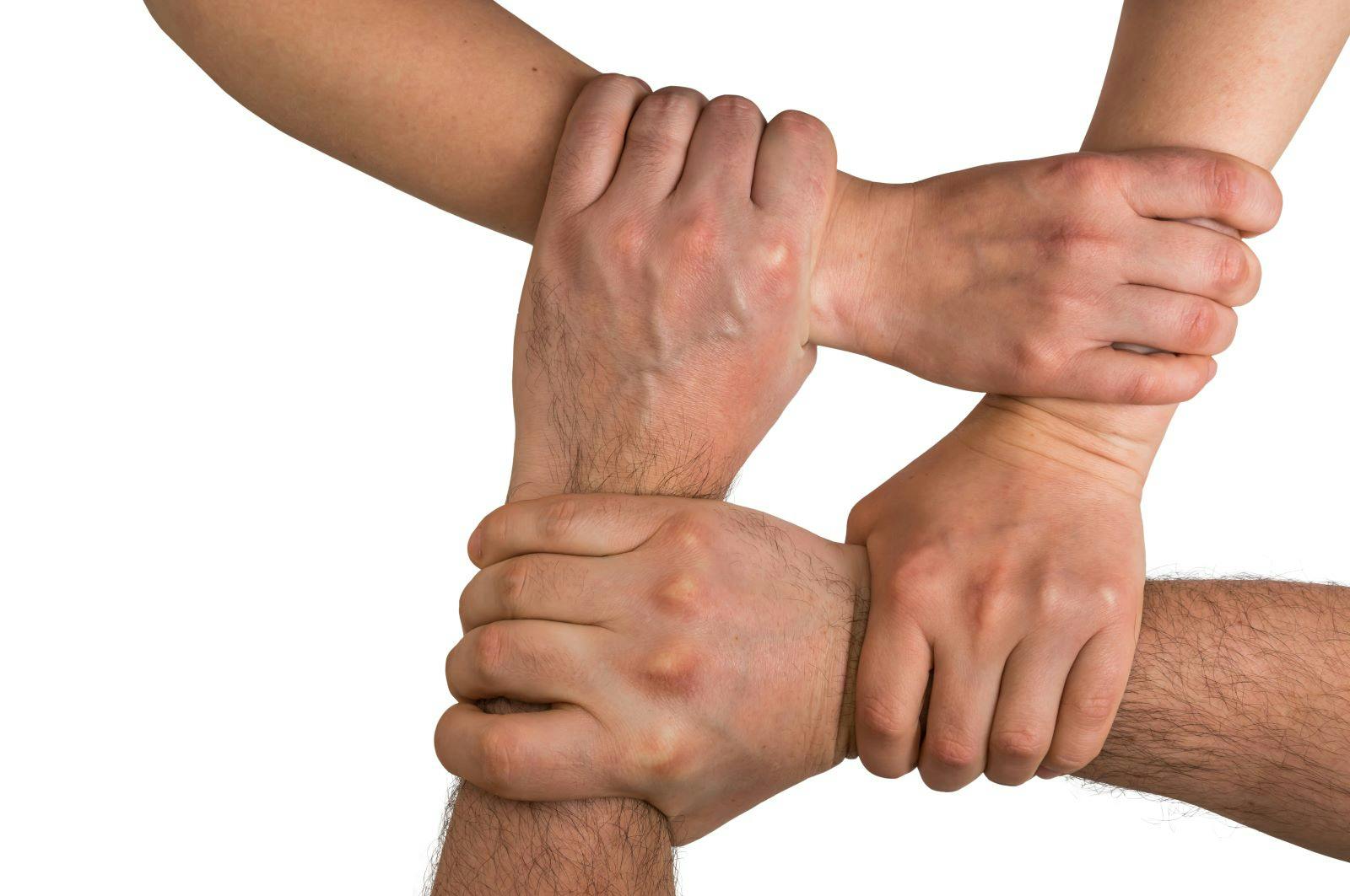 Four interlocking hands