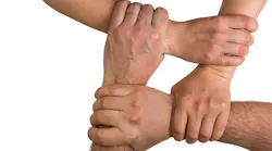 Four interlocking hands Four interlocking hands