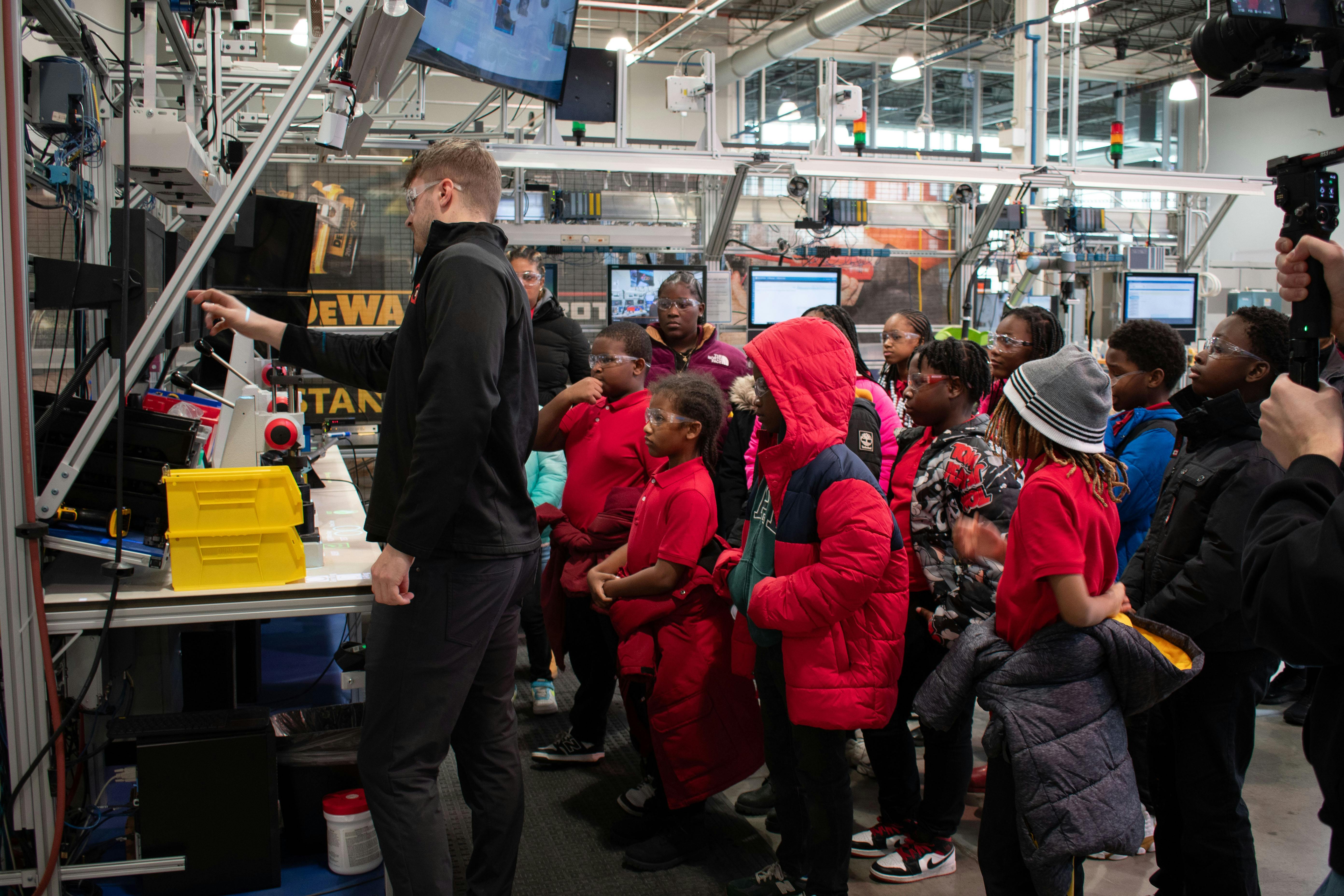 Figure 1: Steady streams of students and other visitors take in the digital and cybersecurity demonstrations at Manufacturing times Digital (MxD) institute, which provides participants with programs in digitalized tools, cybersecurity and workforce expertise.