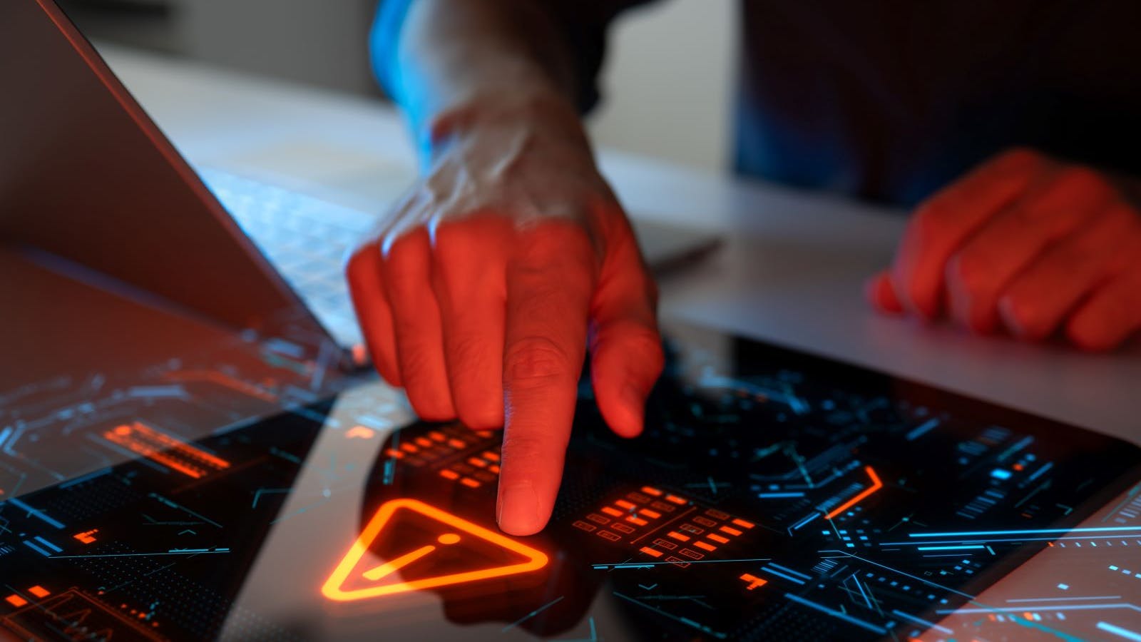 Man interacting with a holographic touchscreen interface in red color. Concept of cyber attack, malware, data breach, system hacking, virus, spyware, compromised information and urgent attention.