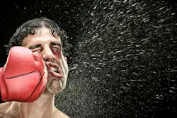 boxer man takes a punch in the face isolated on black. boxer man takes a punch in the face isolated on black.