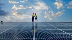 Engineers walking on roof inspect and check solar cell panel by holding equipment box and radio communication Engineers walking on roof inspect and check solar cell panel by holding equipment box and radio communication