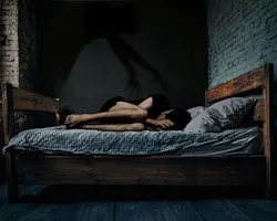 This image captures the chilling essence of sleep paralysis: a person curled in fear, with a shadowy hand looming overhead, symbolizing the helplessness and terror of the experience. This image captures the chilling essence of sleep paralysis: a person curled in fear, with a shadowy hand looming overhead, symbolizing the helplessness and terror of the experience.