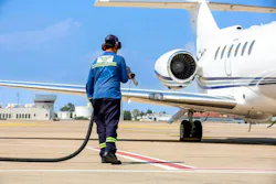 Technician refueling private jet with sustainable aviation fuel at the airport. Technician refueling private jet with sustainable aviation fuel at the airport.