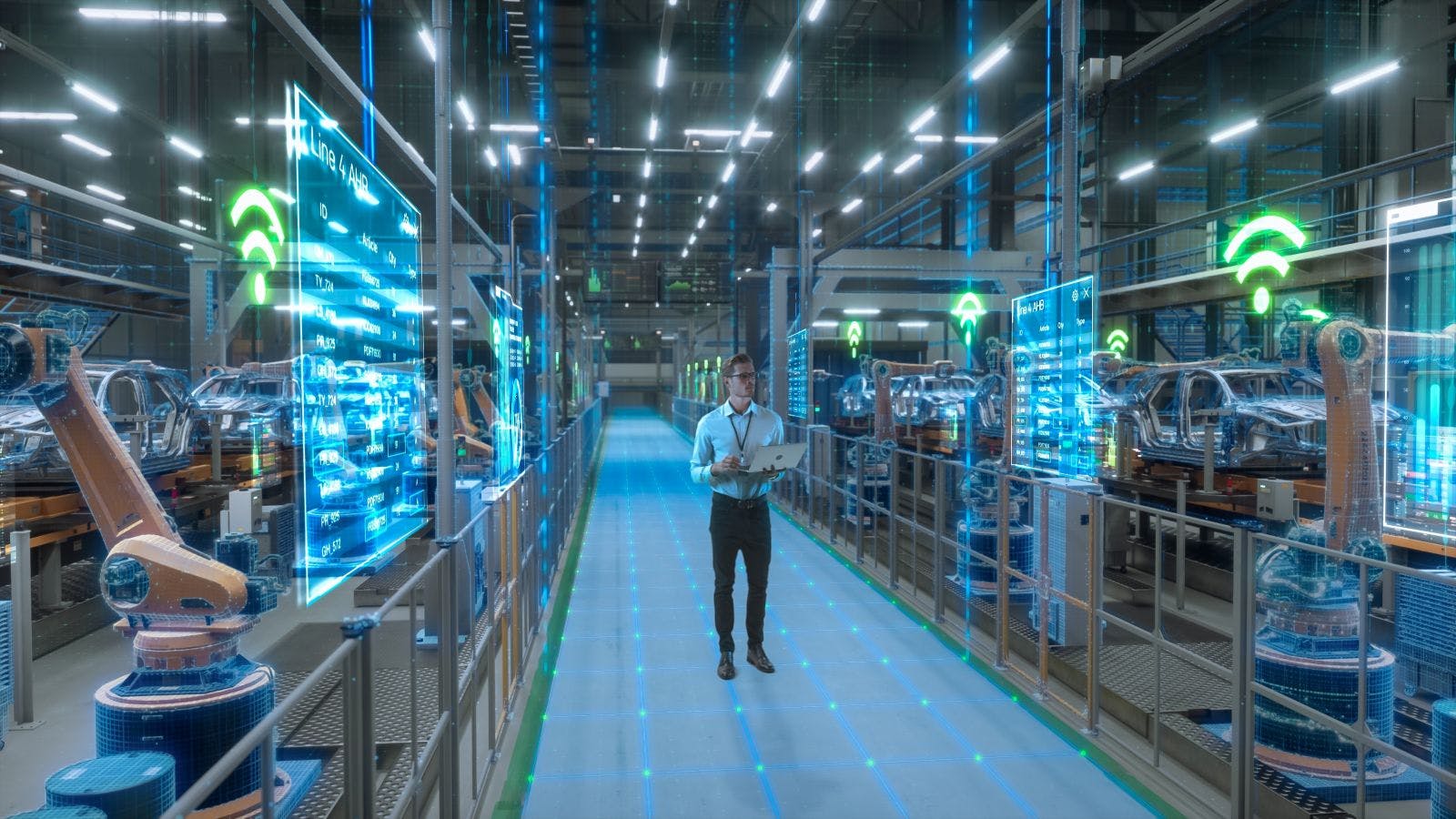 Engineer With Laptop Activates Autonomous EV Factory Digitization. Visualization Shows Robotic Arms, Assembly Line, Digital Twin Lines of Data, Computer Vision Transformation Manufacturing Technology