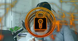 Holding mug, woman wearing gray chunky sweater sitting at home desk, with mic and padlock overlay. Holding mug, woman wearing gray chunky sweater sitting at home desk, with mic and padlock overlay.