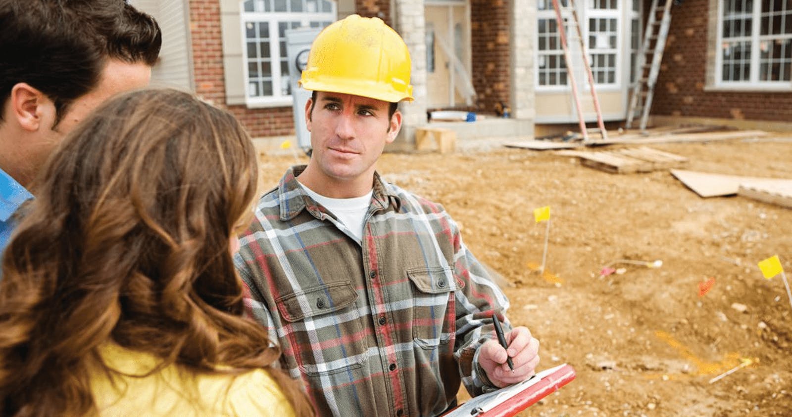 Couple with construction manager wearing a hard hat
