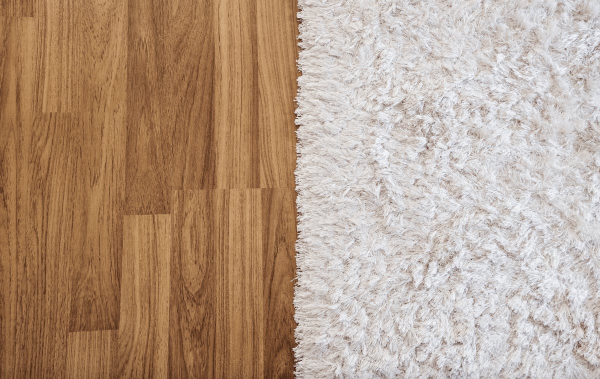 Laminated timber flooring next to white carpet