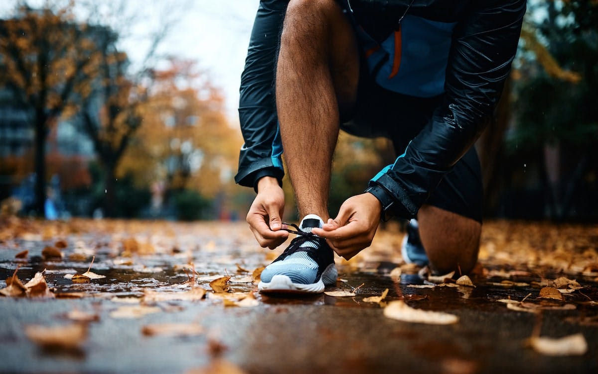 Runner lacing up tennis shoes