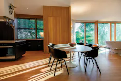 An open-concept living room and kitchen in a pavilion-like space features direct sets An open-concept living room and kitchen in a pavilion-like space features direct sets