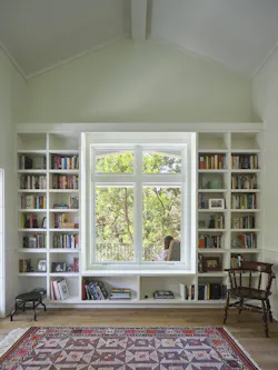 Bookshelves around the large windows keeps the massive storage piece from overpowering the space. Bookshelves around the large windows keeps the massive storage piece from overpowering the space.