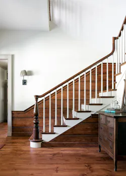 Foyer with wooden staircase and custom-built windows that use an authentic sash weight and pulley system. Foyer with wooden staircase and custom-built windows that use an authentic sash weight and pulley system.